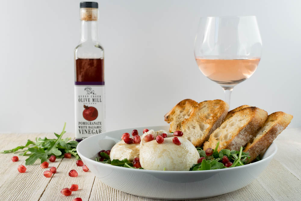 Want a great date night appetizer? The Geeks have created a Burrata Salad with a Pomegranate Vinaigrette featuring Queen Creek Olive Mill Pomegranate White Balsamic Vinegar! [sponsored] 2geekswhoeat.com #DateNight #Cheese #AppetizerRecipes #Mealsfor2 