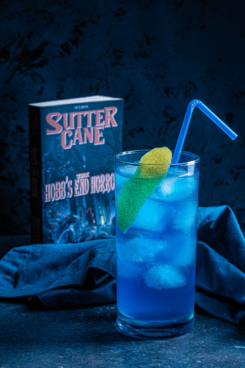 Inspired by John Carpenter's In The Mouth of Madness, The Geeks have created a cocktail perfect for any Sutter Cane fan, the Hobb's End Highball! 2geekswhoeat.com #Cocktails #HomeBartender #HorrorMovieRecipes #HalloweenIdeas #HalloweenParty #MovieNight