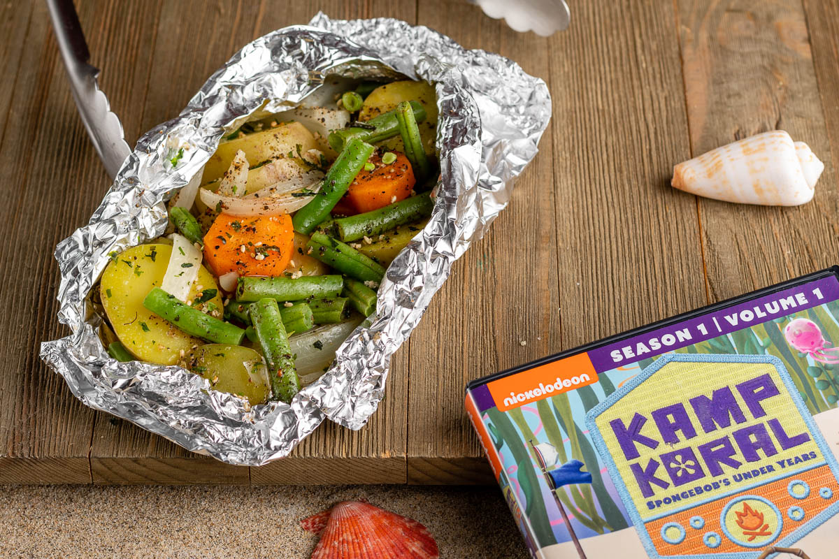 Inspired by the new SpongeBob show, Kamp Koral: SpongeBob's Under Years, The Geeks have put together a recipe for veggie foil packs perfect for summer grilling. 2geekswhoeat.com #Sponsored #Grilling #SummerRecipes #SpongeBobRecipes #GeekyRecipes #GeekyFood