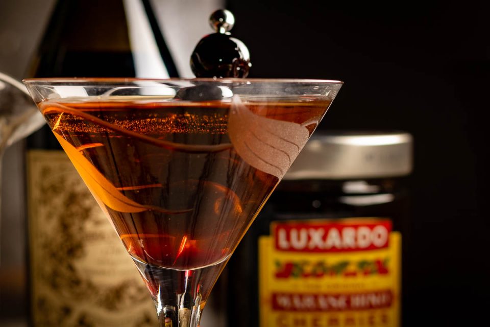 Inspired by the movie Fresh, now on Hulu, The Geeks have created a recipe for Noa's Manhattan, a cocktail featured in the film. 2geekswhoeat.com #HorrorMovieRecipes #Cocktails #CocktailRecipes #HomeBar #ManhattanCocktails